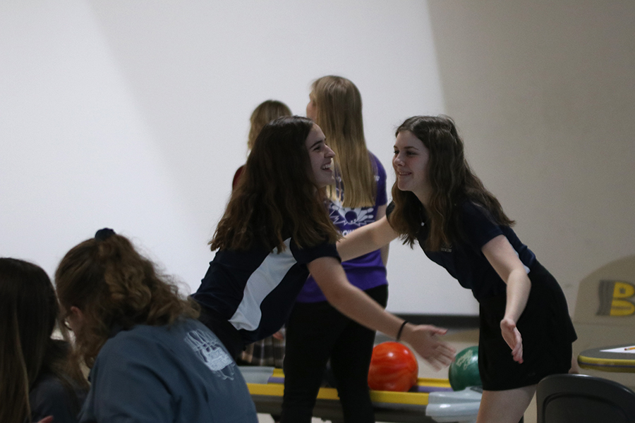 High-fiving, juniors Sophie Hannam and Avery Norman celebrate a strike.