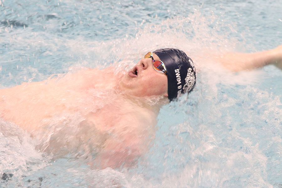 Swimming 100-yard backstroke, senior Logan Myers ends up in second place with a time of 1:01.81.