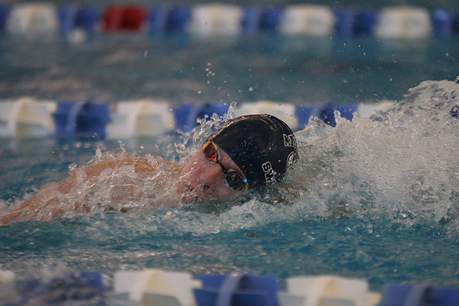 Senior Avery Lawson swims in the 400-yard freestyle relay.