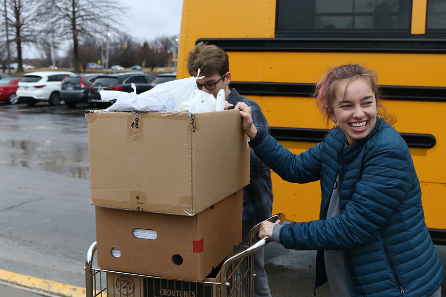 Taking supplies out to the car, senior Belle Baker leaves Monticello Trails with the donations collected from the Youth for Refugees school supplies drive held from Tuesday, Feb. 18 to Friday, Feb. 21.