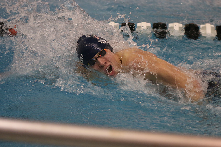 Senior Avery Lawson competes in the 100-yard freestyle.