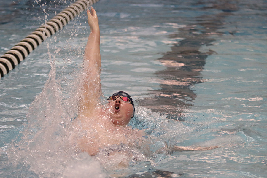 Senior Logan Myers swims in the EKL 100-yard backstroke finals.