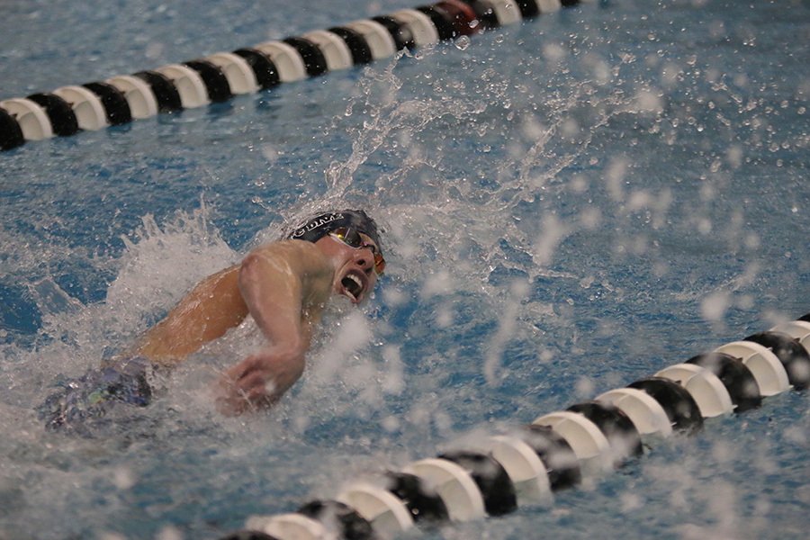 Swimming in the 100-yard freestyle, senior Colby Beggs comes up for air.