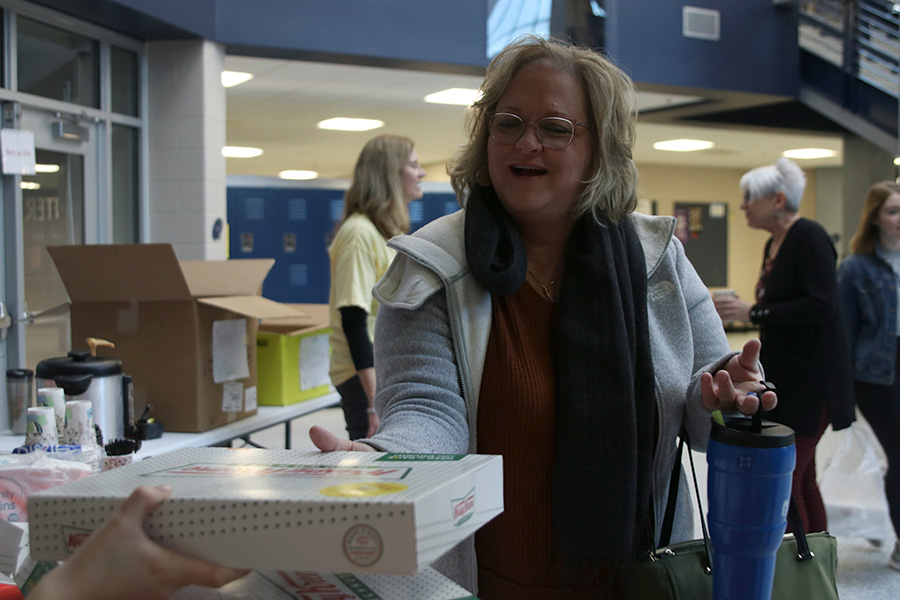 Buying a dozen donuts, paraprofessional Robin Roberts helps support the Spanish NHS fundraiser held Feb. 20 and 21 to help send relief to the citizens of Puerto Rico after the earthquakes they have suffered through this year.
