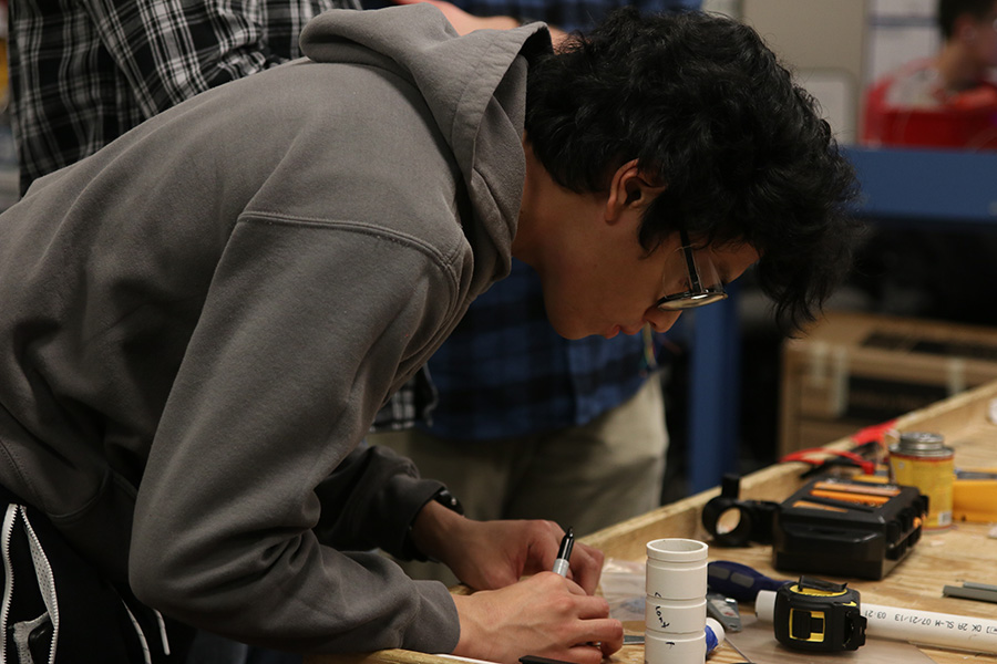 Perfecting a part, senior Nico Gatapia looks closely at his work.
