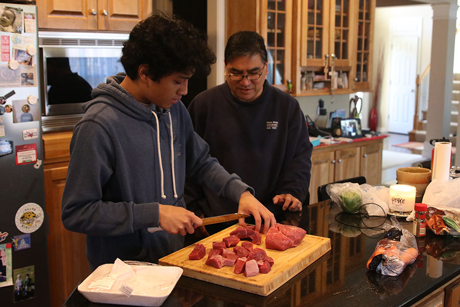 Together, senior Nico Gatapia and his father Ramulus Gatapia make Kaldereta.
