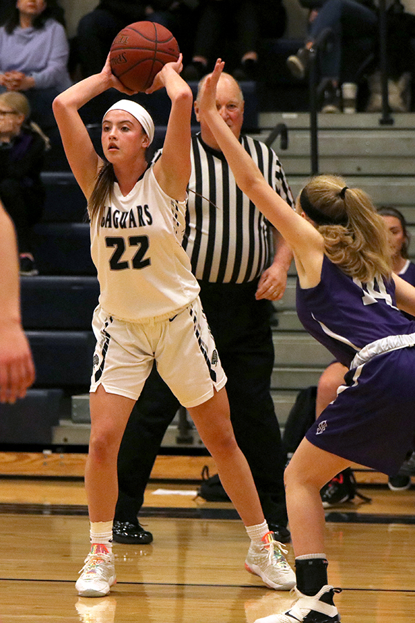 Holding the ball above her head, junior Katherine Weigel prepares to pass the ball to a teammate.