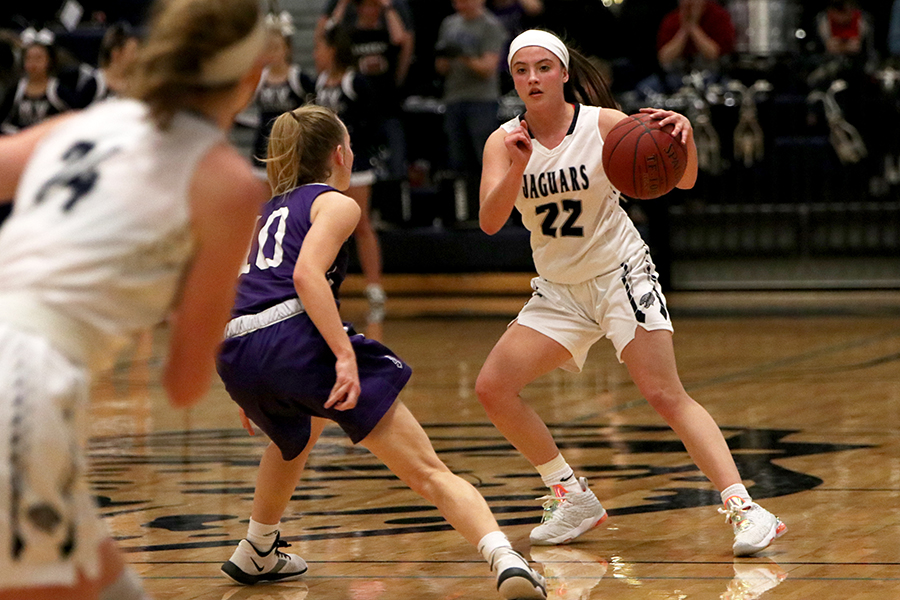 Avoiding a defender, junior Katherine Weigel dribbles the ball.