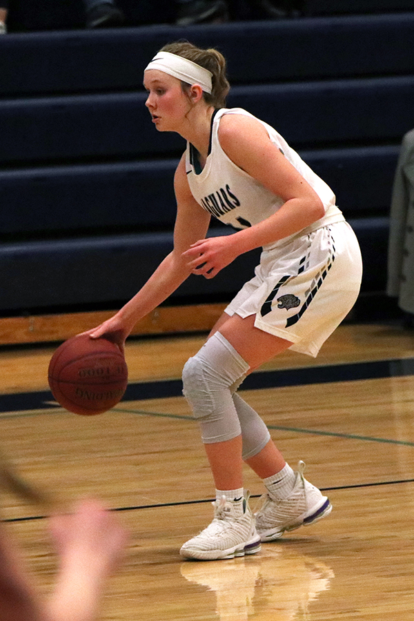 Looking ahead, sophomore Emree Zars dribbles the ball.