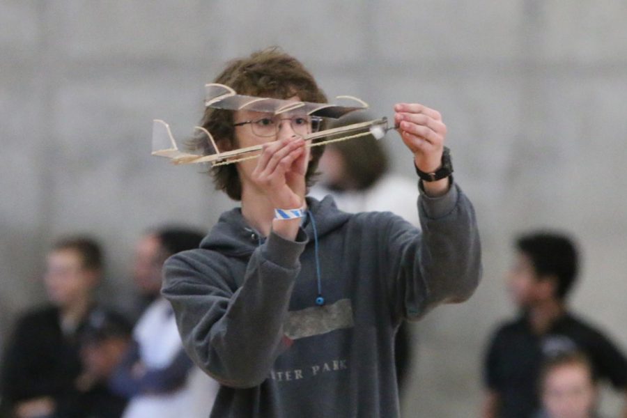 Before releasing his Wright Stuff aircraft for his first official run, sophomore Patrick Mack adjusts the propellers of his build. Wright Stuff is a build event where a team of up to two aims to build the lightest, rubber band-powered propeller airplane that can stay in flight for the longest time. Mack and his partner, junior Andrew Gawith, placed fourth overall at the regionals meet held at Johnson County Community College Saturday, Feb. 29.