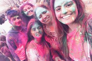 Covered in vibrant colors with his family, senior Amit Kaushal enjoys the 2019 Hindu Festival of Holi.