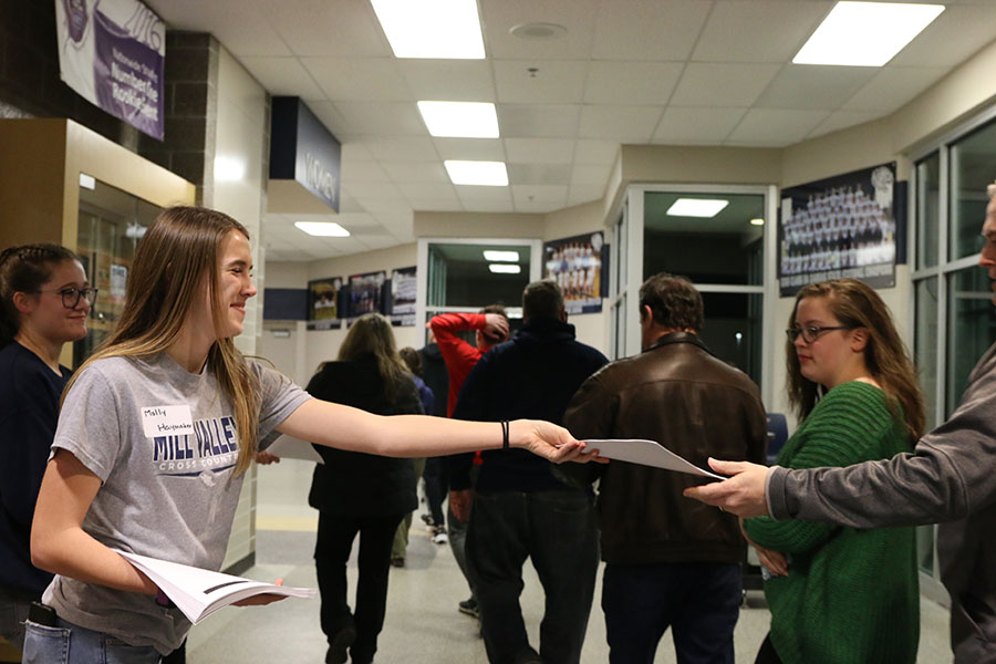 Handing out a pamphlet, senior Molly Haymaker gives out all the information about Incoming Freshmen Night.