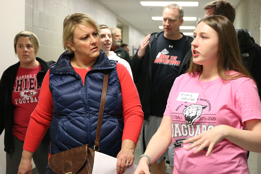 Giving the tour, sophomore Ashley Atkinson gives incoming freshmen and their parents a tour around the school.