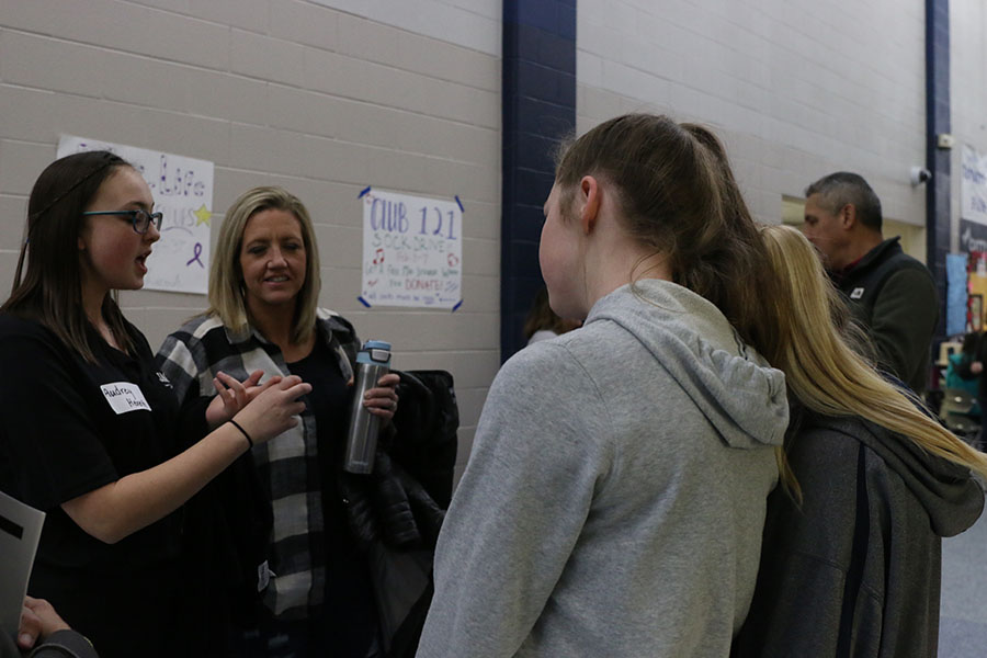 Helping with questions, junior Aubrey Hereth answers any questions that they have. 

