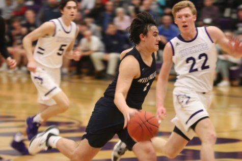 Sprinting down the field, senior Brayden Whisler, goes for the layup after stealing the ball from Blue Valley Northwest. The team fell 88-41 Tuesday, Feb. 18. 