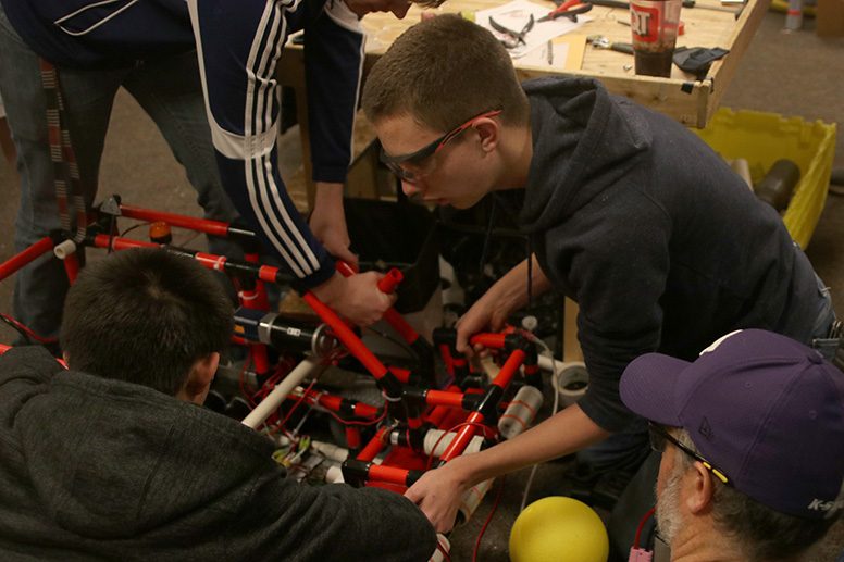 A group of students on the robotics team make a change to their robot’s design at practice Thursday, Feb 6.
