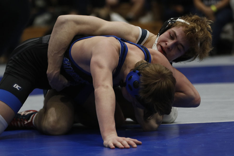 With a tight hold on his opponent, senior Cole Moberly looks to take control of the match.