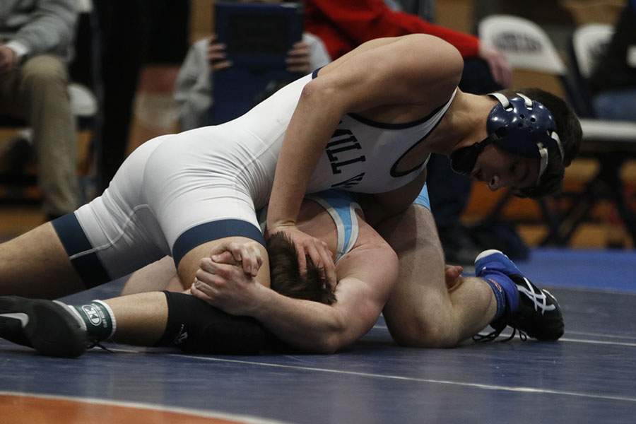 Not giving his opponent any chance of escape, senior Austin Keal maintains the upper position.