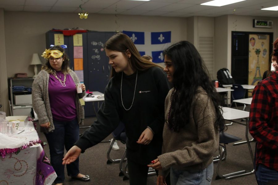 While playing a ring toss game, junior Morgan Prosser prepares to throw a ring. To celebrate Mardi Gras, french teacher Charisse Highlander’s classes participated in games, music and ate the traditional Mardis Gras king cake Monday, Feb. 24 and Tuesday, Feb. 25. 