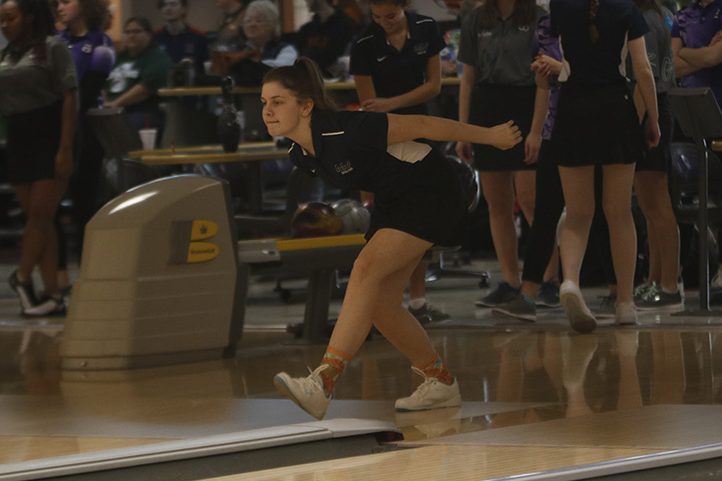 Swinging her arm back, junior Sophie Hannam prepares to release the ball. The girls varsity team won first overall in their competition Thursday Feb 6. 