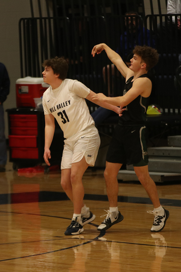 Looking toward the ball, senior Cole Weber defends his teammates.