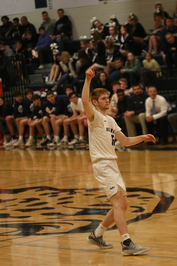 Stepping back, senior Braeden Wiltse prepares to run across the court.
