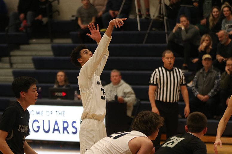 Arms in the air, sophomore Adrian Dimond shoots a free throw. On Tuesday, Feb. 26, the boys basketball team defeated Blue Valley Southwest 54-39.

