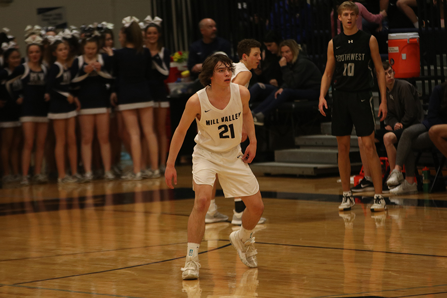 Focused on stealing the ball, junior Noah McCoy prepares to run forward.
