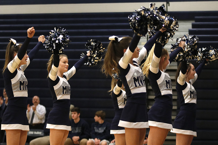 Cheerleaders get the student section exited before the pep assembly for wrestling winning state.