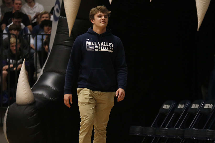 Walking out of the inflatable jaguar junior Dalton Harvey heads to his seat after assembly host Mick Shaffer announces his name.