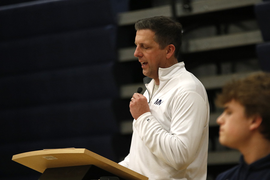 Assembly host Mick Shaffer congratulates the wrestling team on their 6A state title.