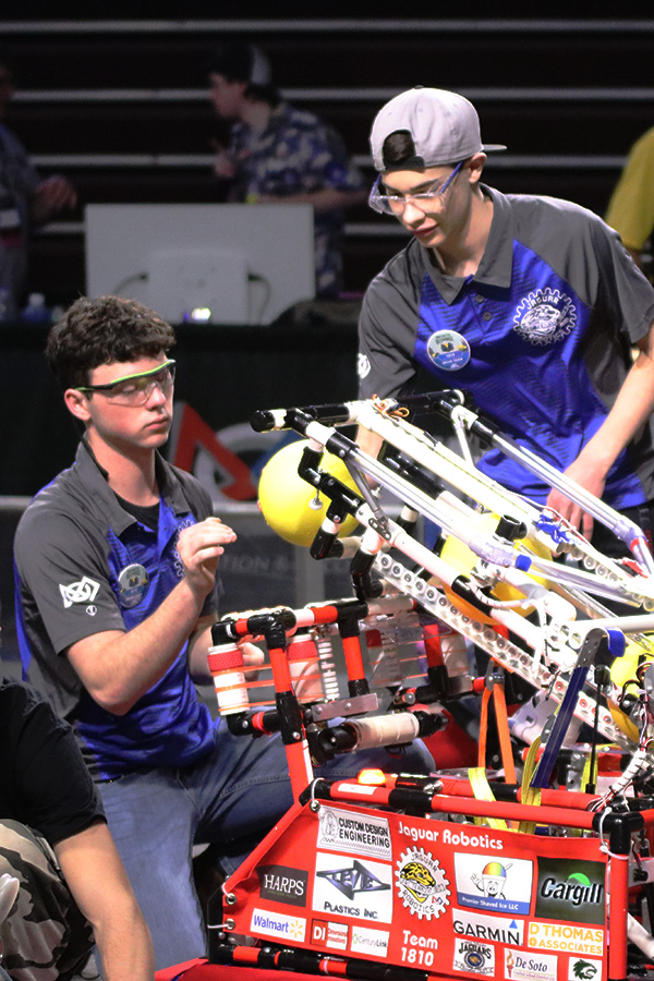 Prepping on the field for the next match, the drive team loads the robot with balls so the robot can score points during the autonomous period. 