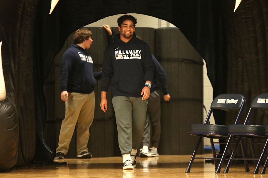 At the pep assembly in honor of the wrestling team winning their first 6A State Championship, senior Tyler Green walks through the Jaguar to his seat. Green won his first individual 6A State Championship in 195-pound against a 40-0 opponent from Washburn Rural.