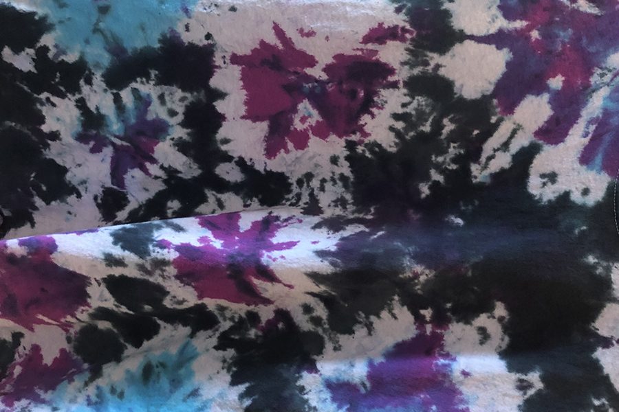 This tie-dyed shirt was dyed with the polka dot technique, tying several dots across the shirt and placing an accent dye in the blank space between.  