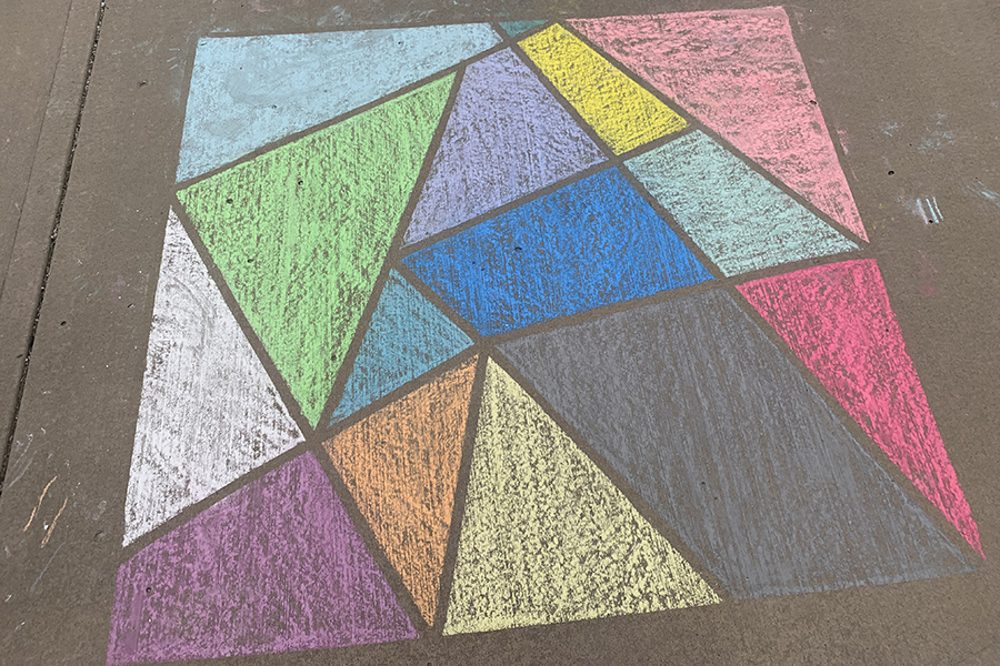For fun abstract triangle art: define your work space with masking tape on your sidewalk or driveway. Then break the area into smaller pieces with several diagonal lines with the tape. Color with solid or ombre techniques, then remove tape for easy sidewalk art.