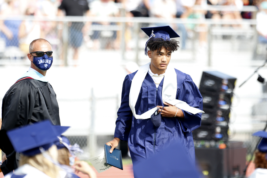 After  picking up his diploma, senior Zach Mills walks back to his seat. 
