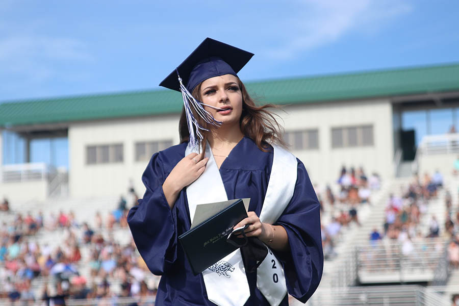 Returning to her seat, senior Ashley Albertson watches her fellow classmates receive their diplomas. 