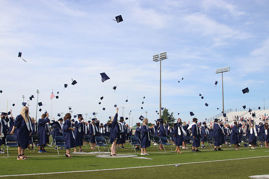 In a celebratory manner, the senior class of 2020 throws their graduation caps in the air on Saturday, July 25.