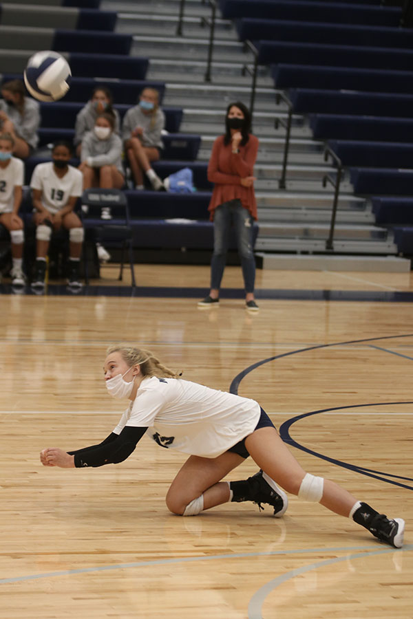 Diving, junior Annabelle Manning attempts to save the ball from hitting the ground.