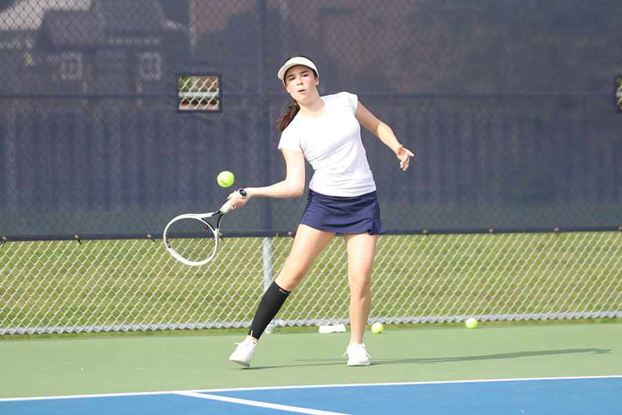 Hitting a forehand, junior Eden Schanker hits the ball to her opponent. She competed in doubles and singles Tuesday, Sept. 15 against Olathe South.