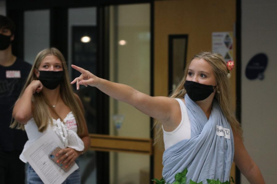 Pointing toward the iconic jaguar statue in the main hallway, junior Avery Davis gives a group of freshmen a tour during freshman orientation, Tuesday, September 8. 