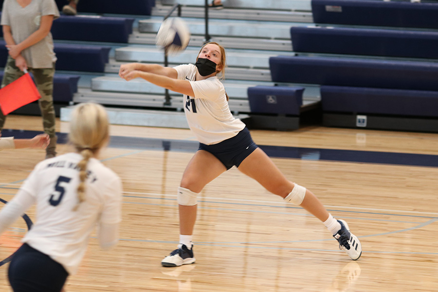 Eyes on the ball, junior Brylee Peterson bumps the ball over the net.The girls volleyball team won a triangular against Olathe South and Olathe West, beating South in two sets and West in three sets. They played Thursday, Sept. 17 in the new home gym.