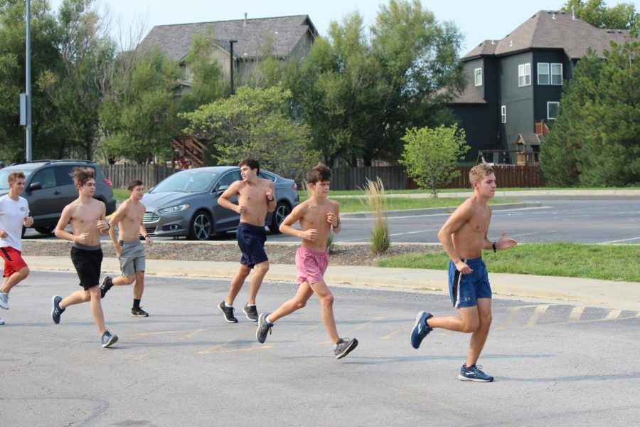 Leading the rest of the team, junior Brendan Akehurst starts his run ahead of the others to keep a safe distance.