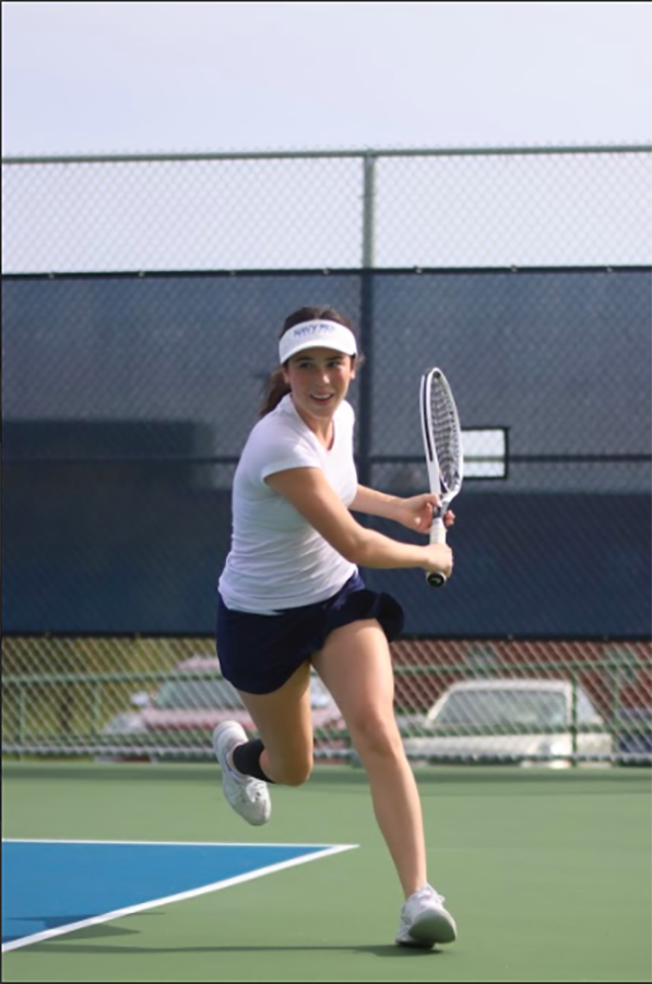 Running toward the ball, junior Eden Schanker prepares to hit the ball. 
