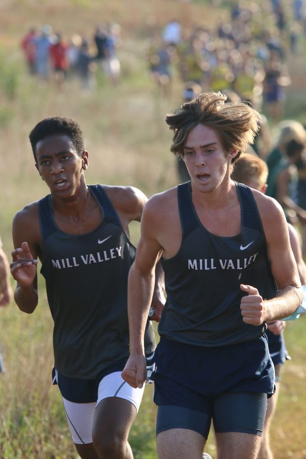 Running together, both freshmen AJ Vega and junior Chase Schieber keep on pushing forward.