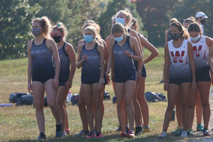 Ready to go, varsity cross country girls at the start of the race.