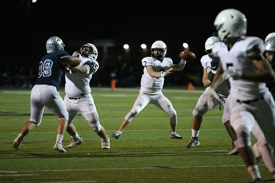 Looking at his target, quarterback Cooper Marsh gets ready to throw the ball to his teammate. 