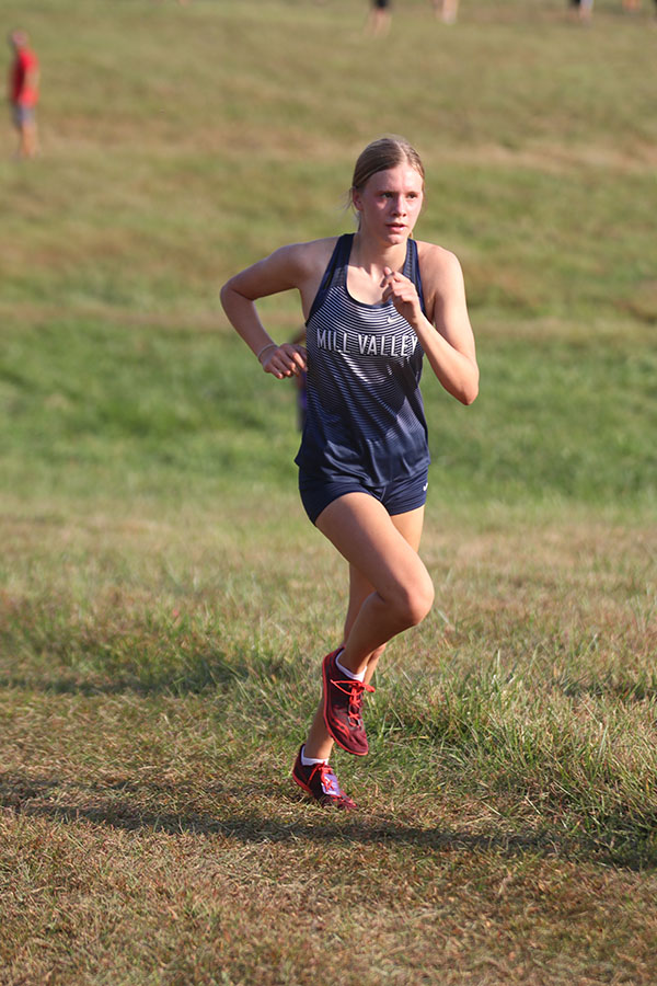 Eyes on the finish line, junior Katie Schwartzkopf pushes herself in the last seconds of her race.