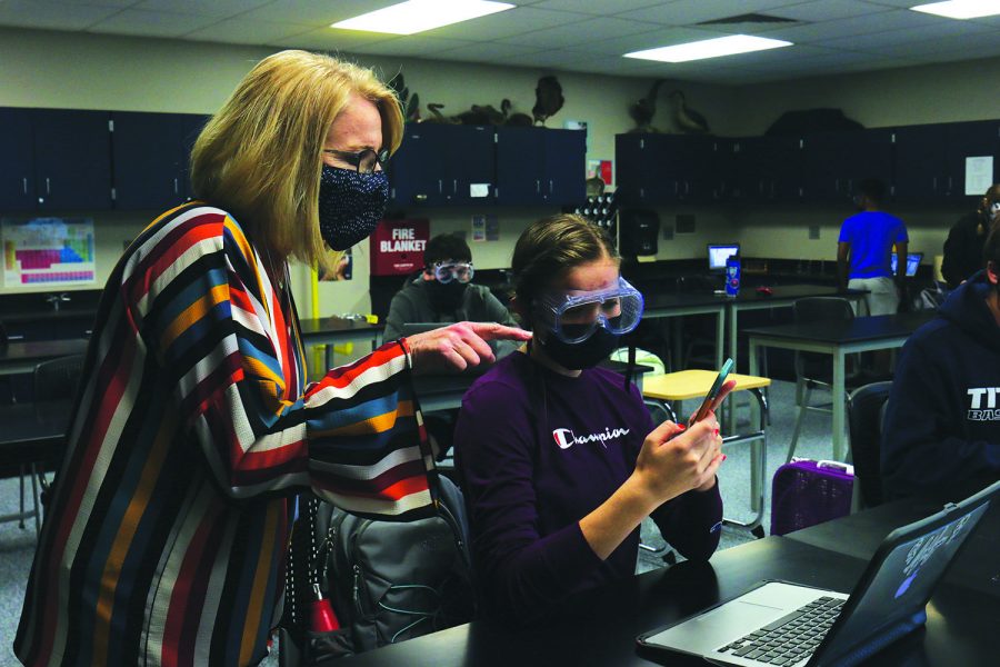 Stepping into science teacher Jill Lloyd’s chemistry class, principal Dr. Gail Holder discusses the results of an experiment with a student Friday, Oct. 9.