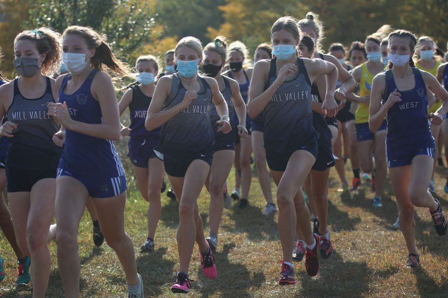 Side by side, juniors Bridget Roy and Katie Schwartzkopf begin the race with their masks on.